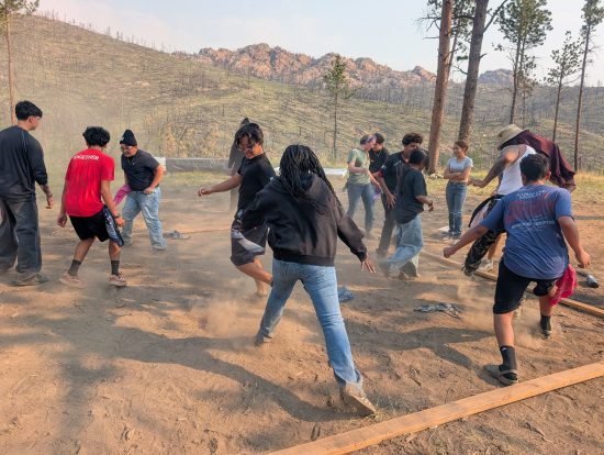 Horizons students play games outdoors during their wildfire-focused camping trip.