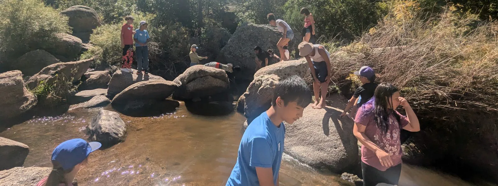 AXL Academy students enjoy creek exploration during their CAP field day trip.
