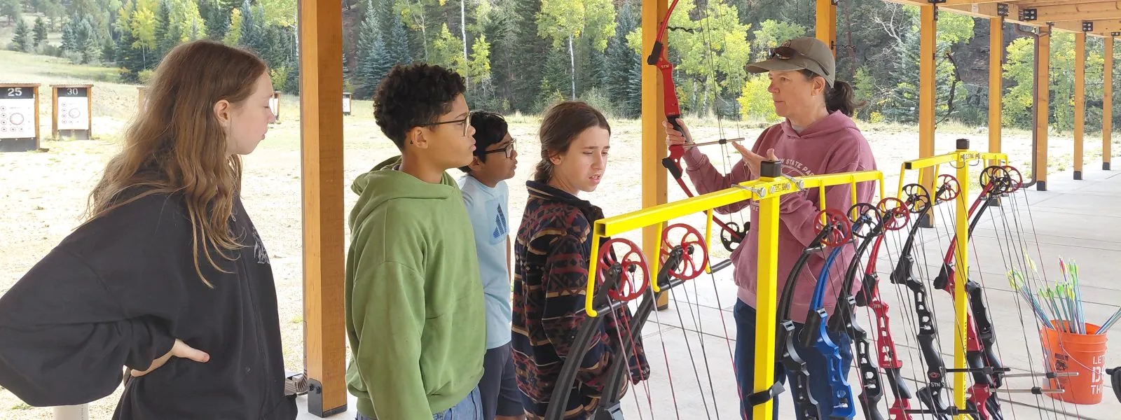 AXL students line up to learn about bows for archery during their Outdoor Wellness Day.