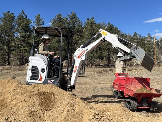 Lahja operates an excavator during trail restoration work.