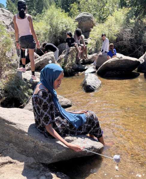 AXL students hang out by the river and enjoy the cool water and wildlife explorations.