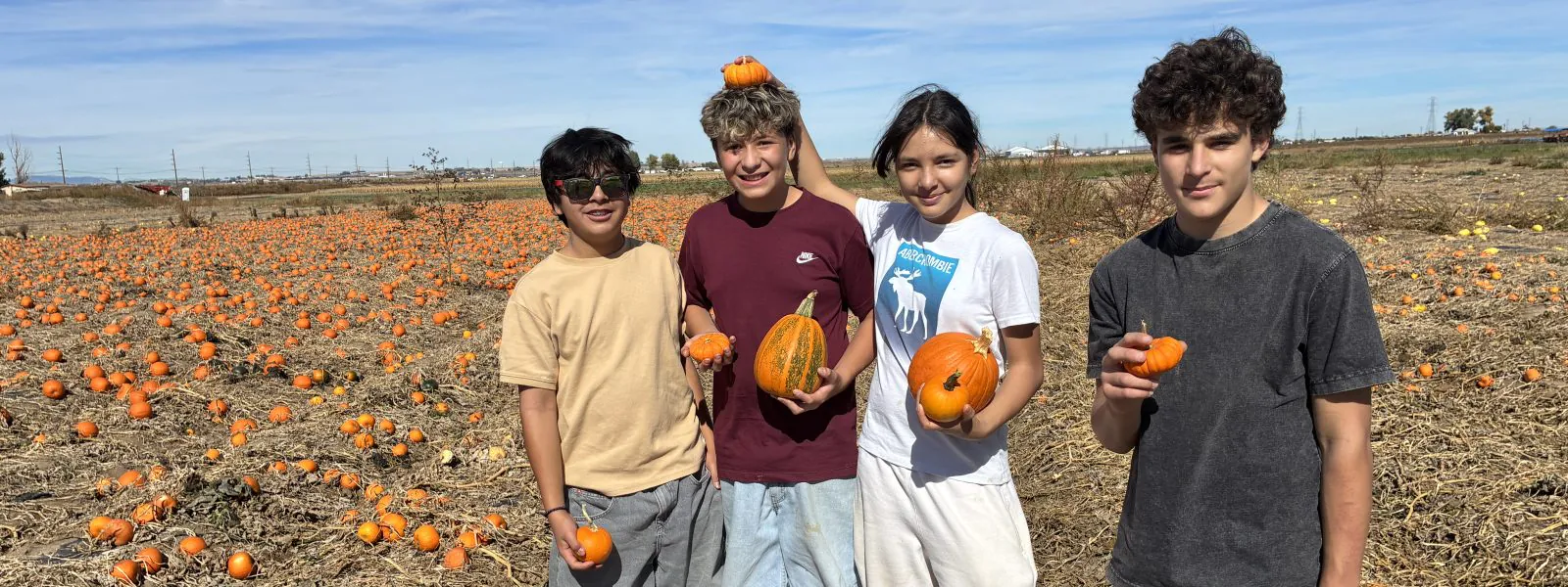 LEO students pose with pumpkins during their day of farm-based learning.