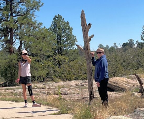 AXL students pose by a dead tree during their wildlife explorations of Castlewood Canyon.